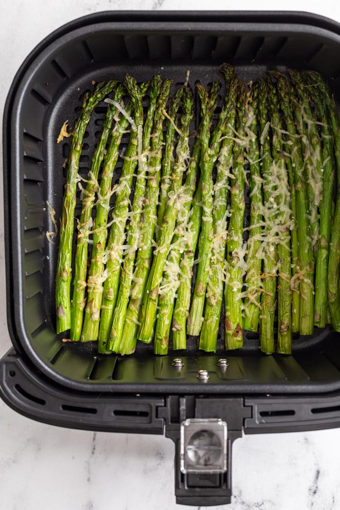asparagus air fryer cooked and toped with cheese