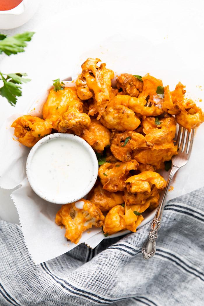 air fryer buffalo cauliflower served with a white dipping sauce