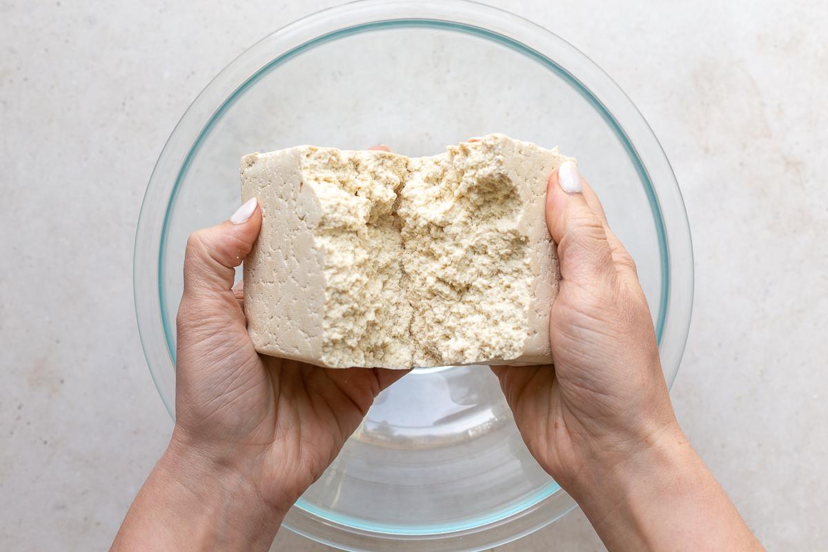 a block of tofu being torn in half