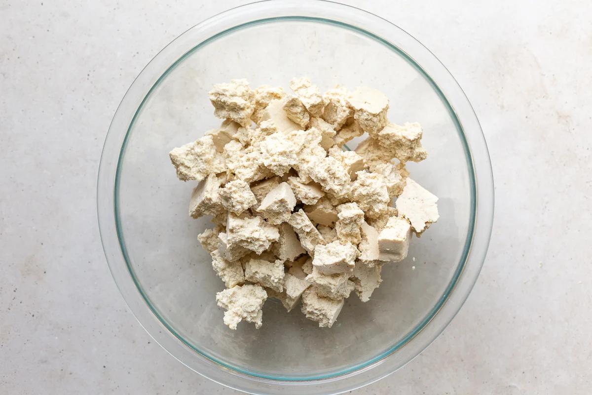 tofu torn into chunks placed in a large bowl