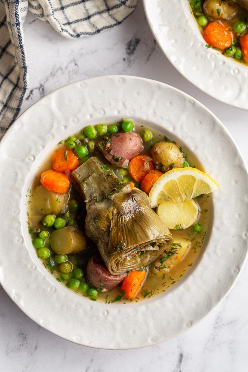 artichokes constantinople- steamed artichoke in a veggie stew with a lemon wedge