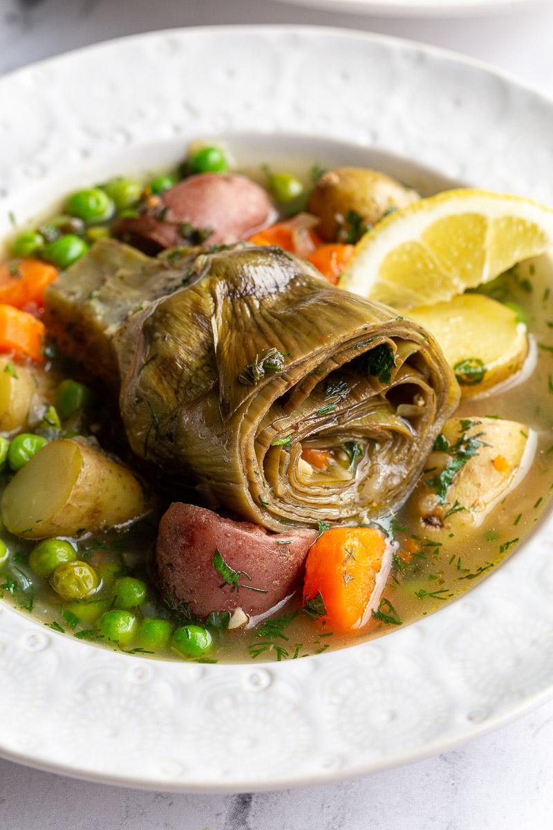 artichokes constantinople- steamed artichoke in a veggie stew with a lemon wedge