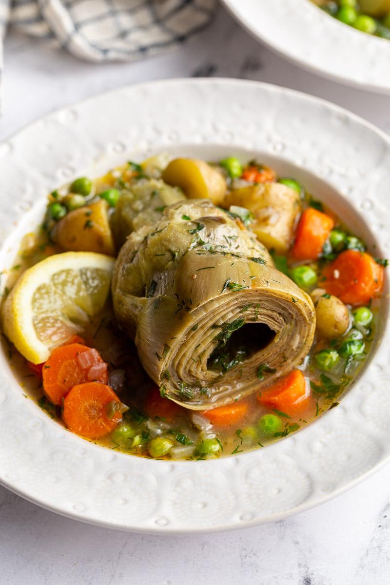 artichokes constantinople- steamed artichoke in a veggie stew with a lemon wedge