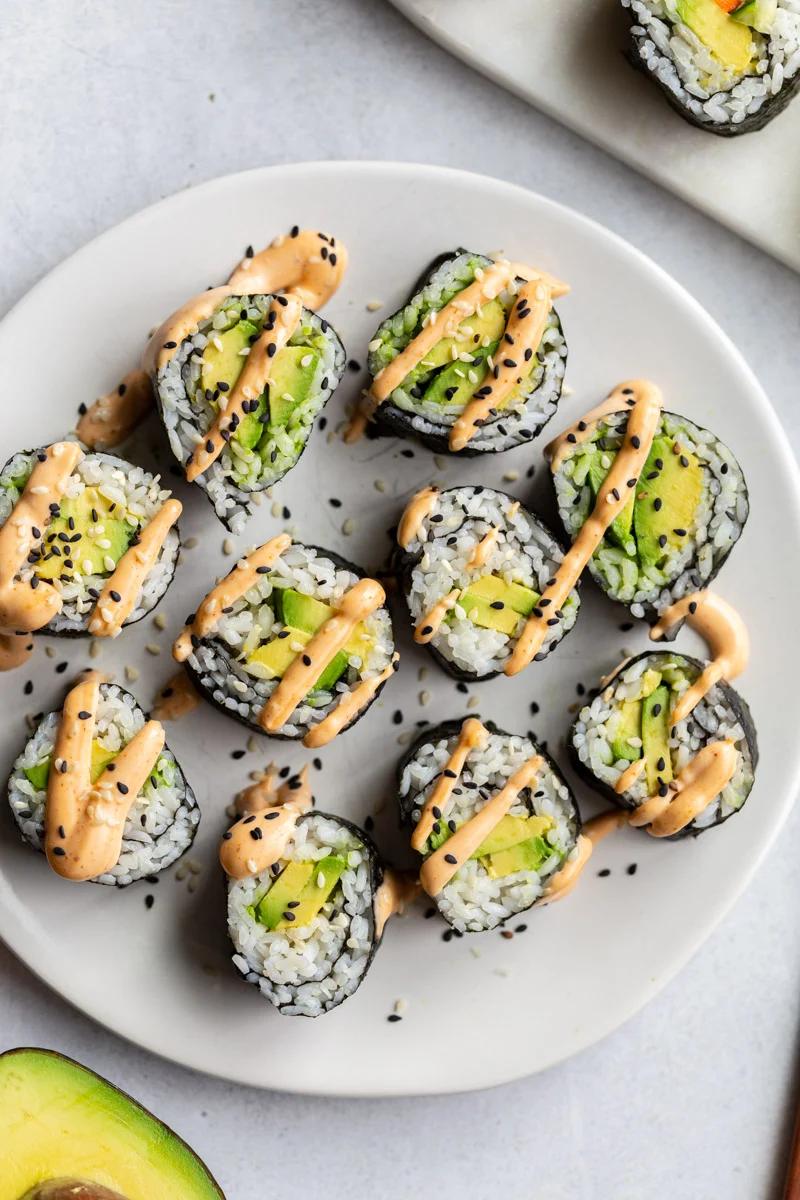 avocado sushi rolls topped with spicy mayo