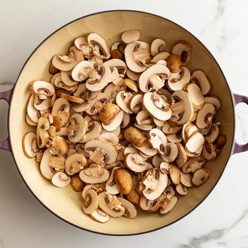 baby bella mushrooms in a skillet