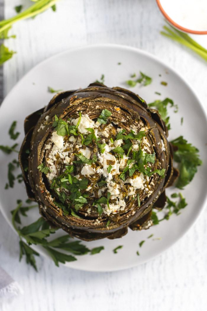baked artichoke topped with feta and parsley