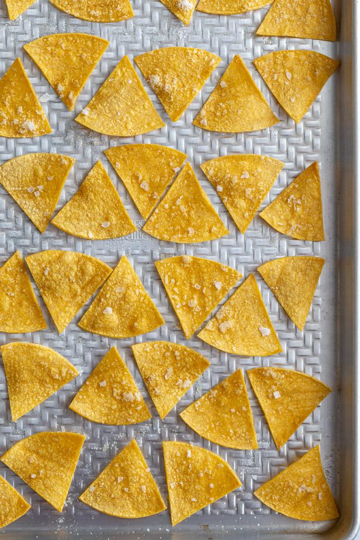 from-scratch tortilla chips lined up on a baking sheet