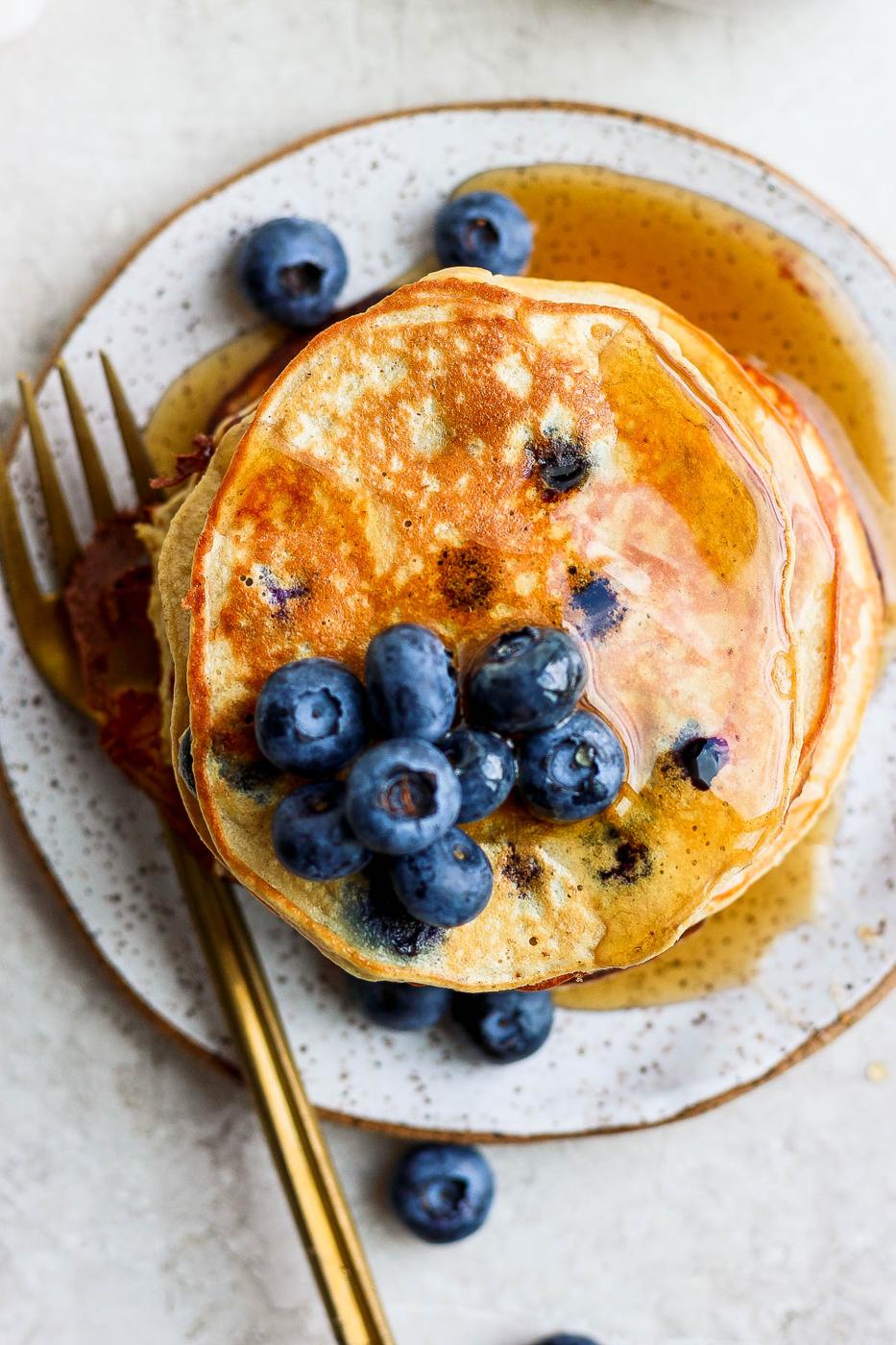 Pancakes topped with fresh blueberries.
