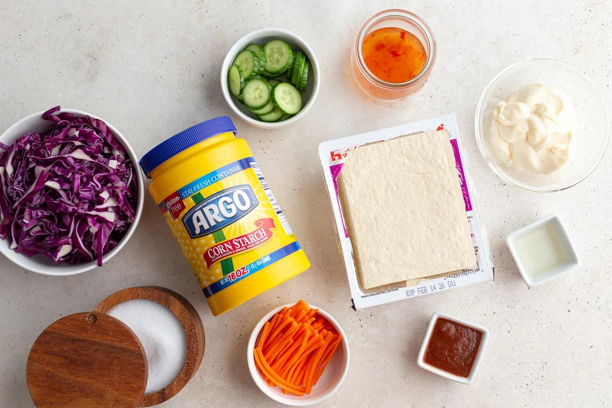 ingredients needed to make bang bang tofu including tofu, cornstarch, sweet chili sauce, mayo, etc