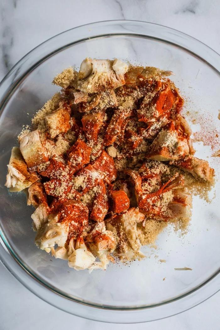 large bowl of jackfruit pieces with spices on top including paprika