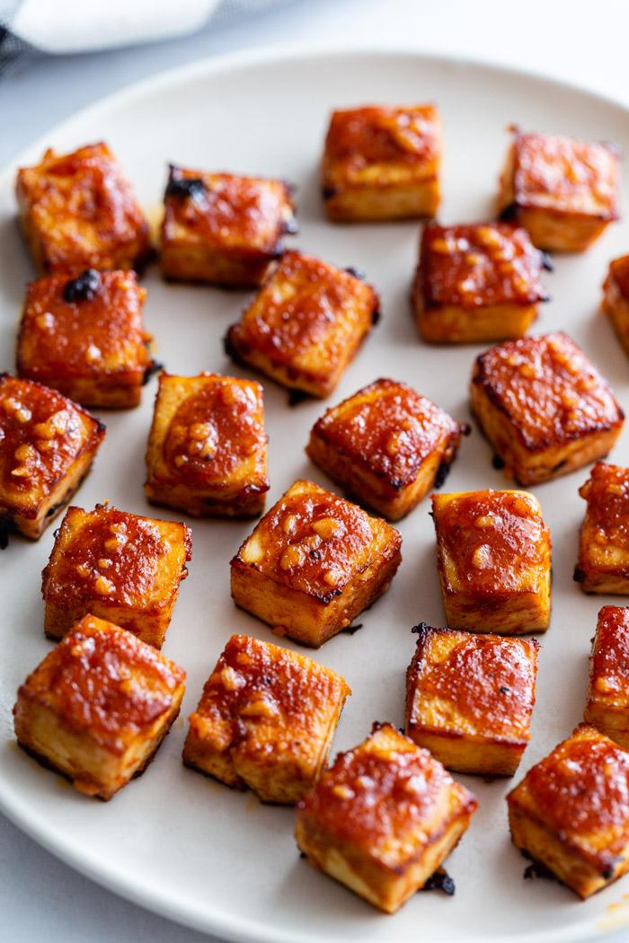 plate of bbq tofu cubes covered in sauce