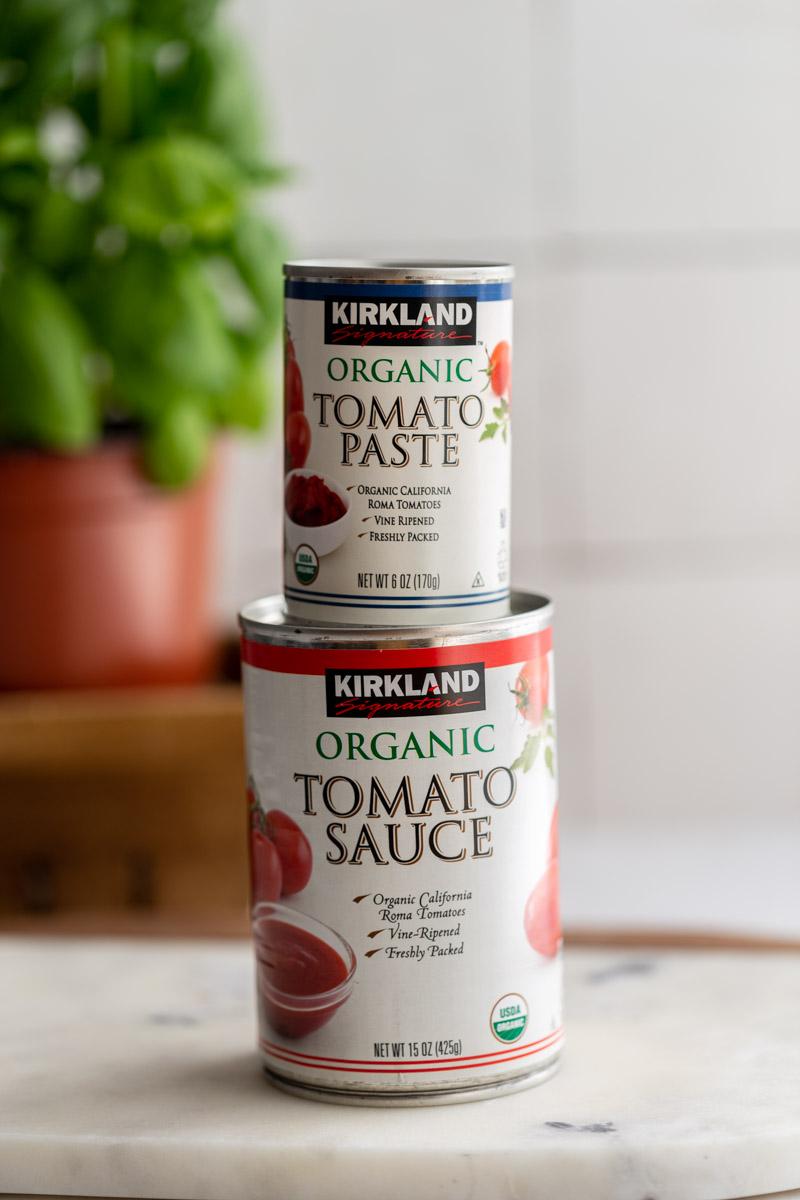 jar of tomato paste on top of a jar of tomato sauce