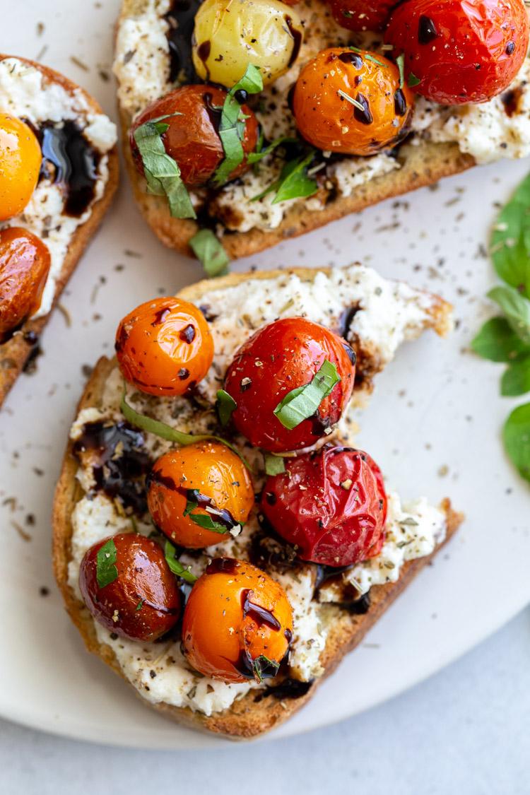 blistered tomatoes served over toast with balsamic glaze