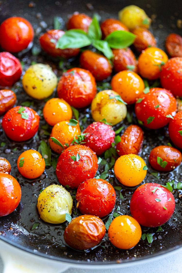 cherry tomatoes cooking in a skillet