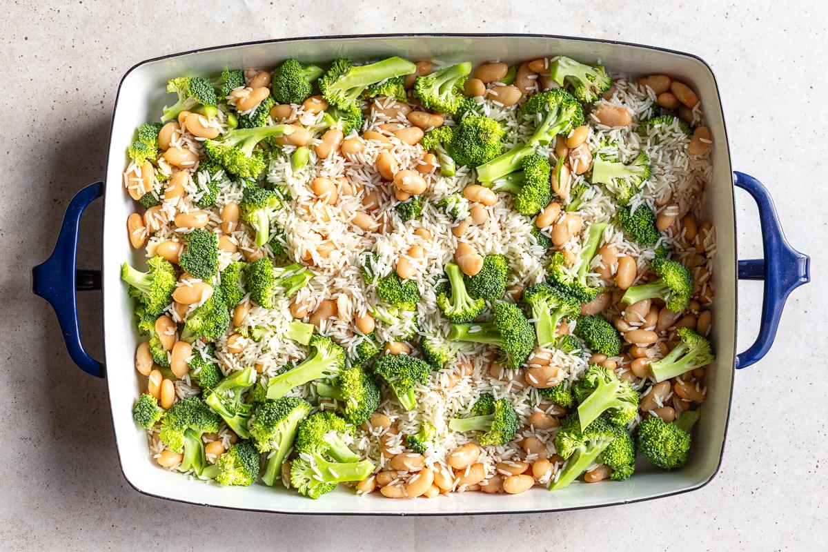 how to make cheesy broccoli rice casserole. riice, broccoli and beans in a casserole dish