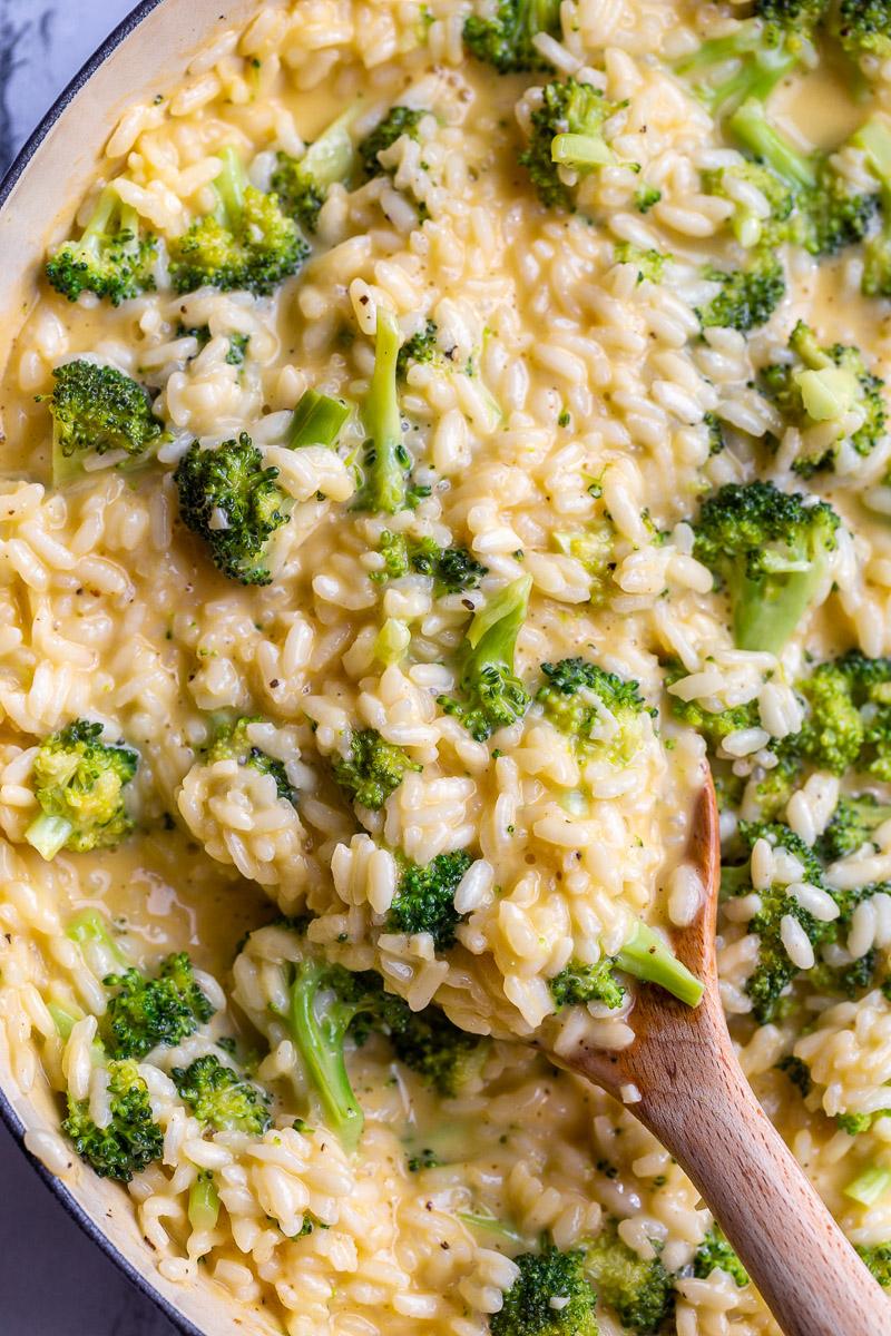 Stirring risotto with a wooden spoon.