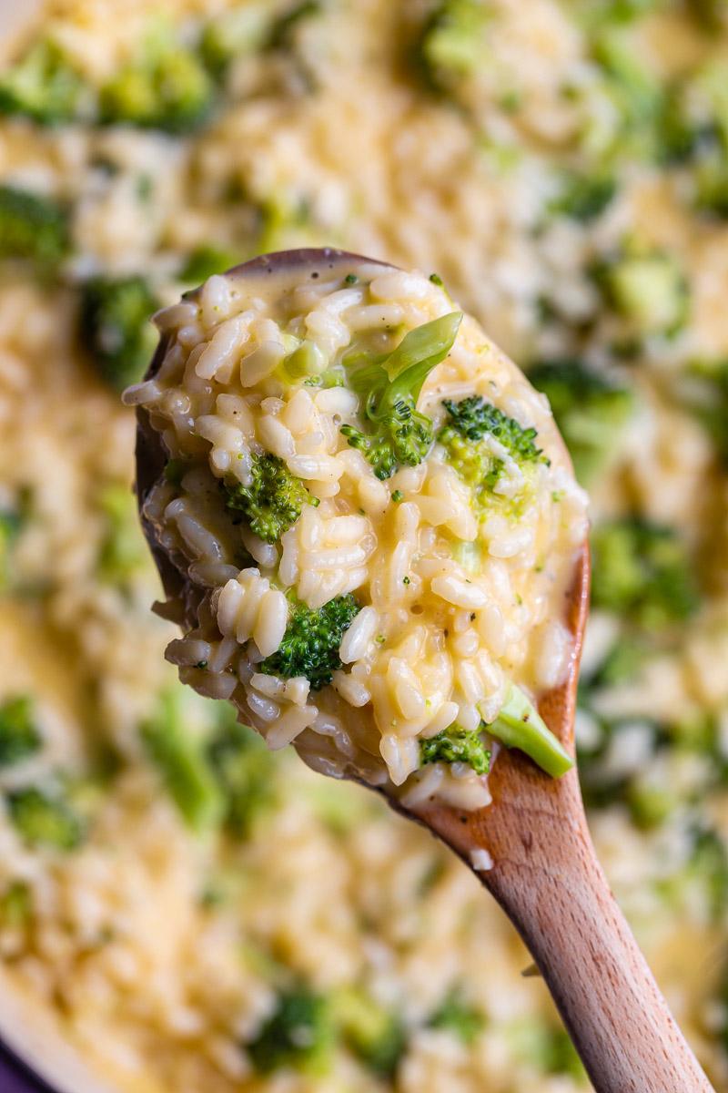 Wooden spoonful of cheesy risotto.