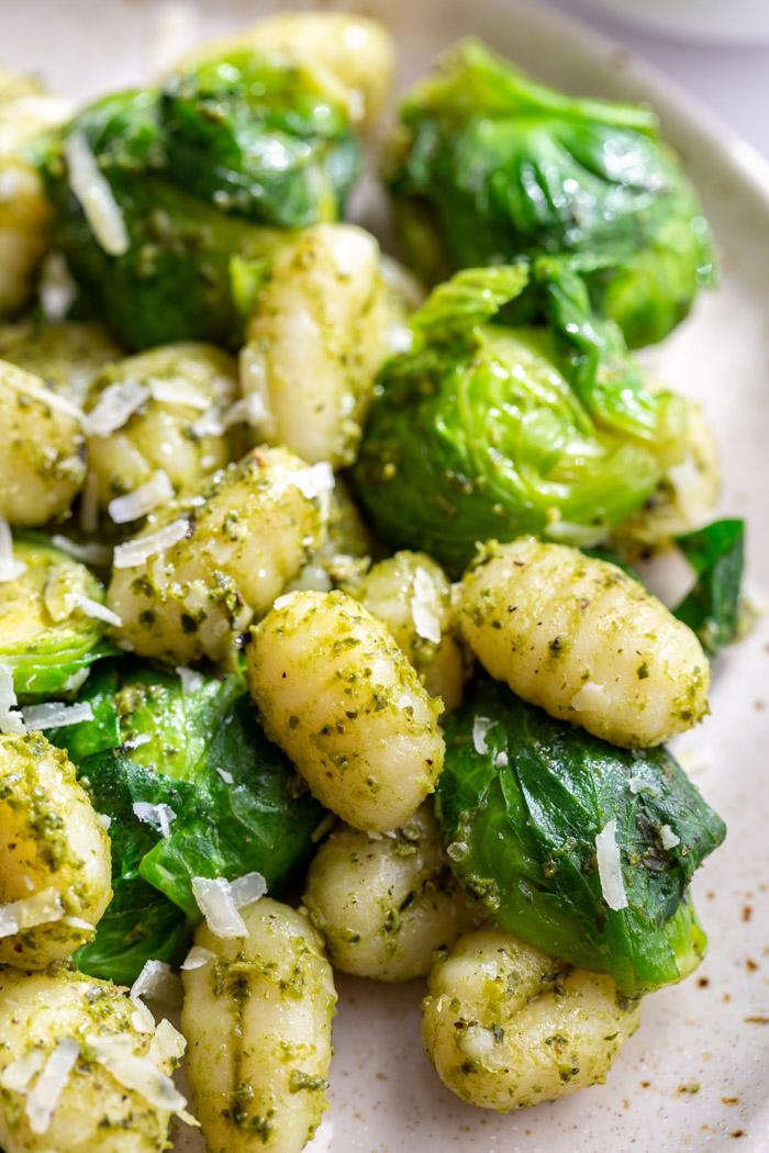 up close shot of pesto gnocchi with brussels sprouts