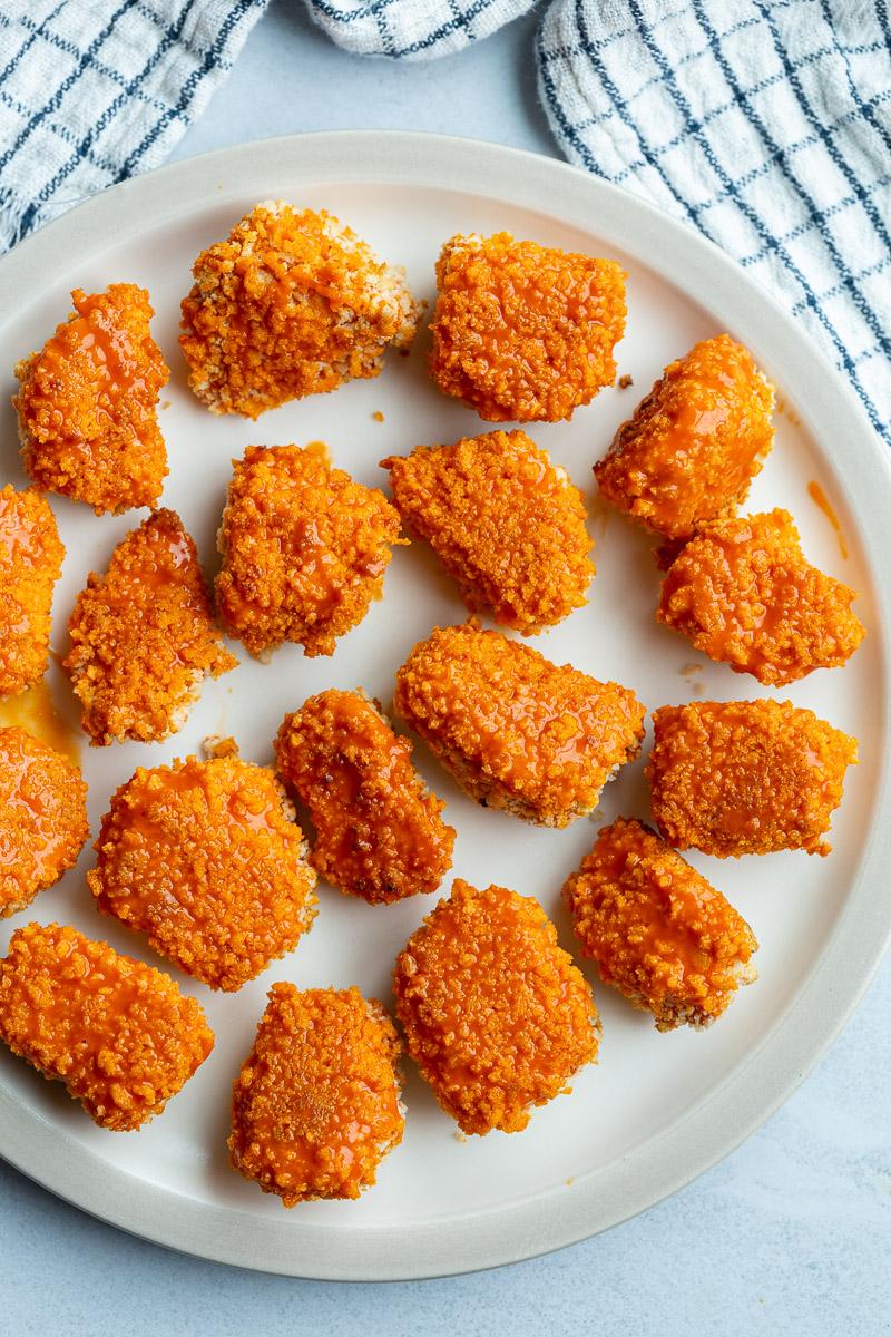 Crisp pieces of tofu on a white plate.