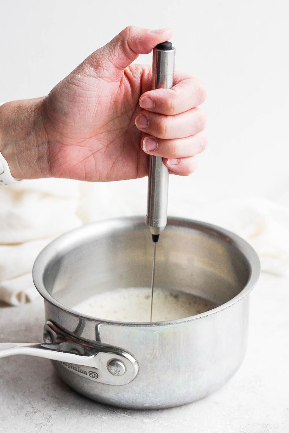 Frothing milk in a pot.