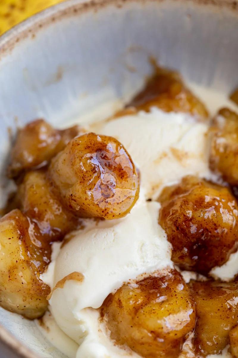 caramelized bananas served over a scoop of vanilla ice cream