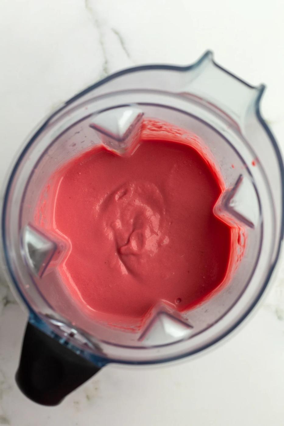 beet and white bean puree in a blender with a vibrant pink color