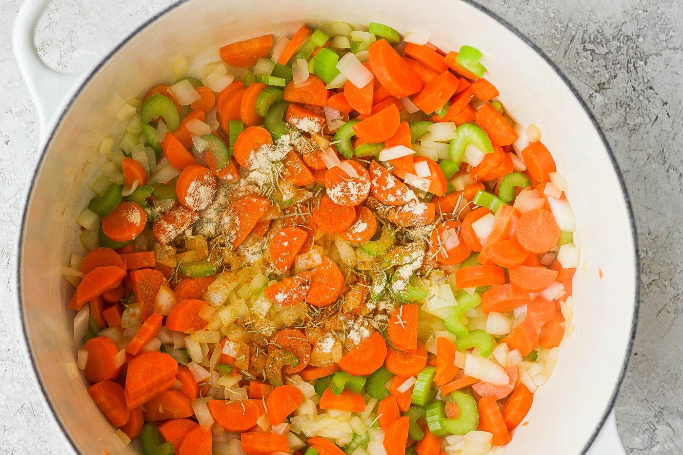 Sautéing veggies in a large pot.