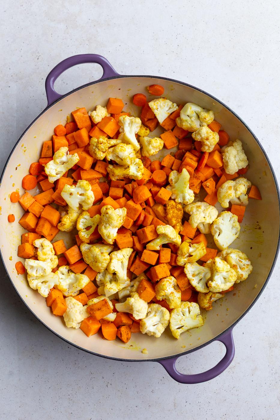 carrot, sweet potato and cauliflower in a skillet with curry powder