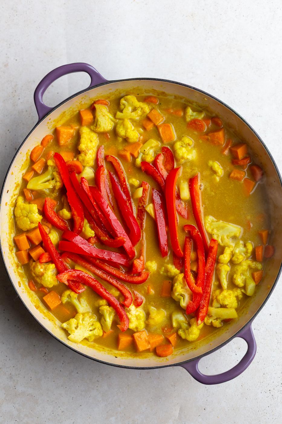 HOW TO MAKE A SWEET POTATO CURRY: veggies in a skillet with a curry sauce