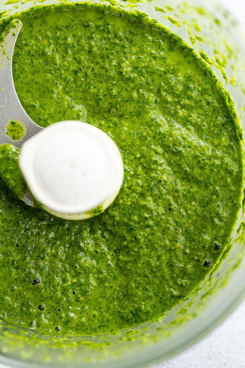 Mixing herbs in a food processor.
