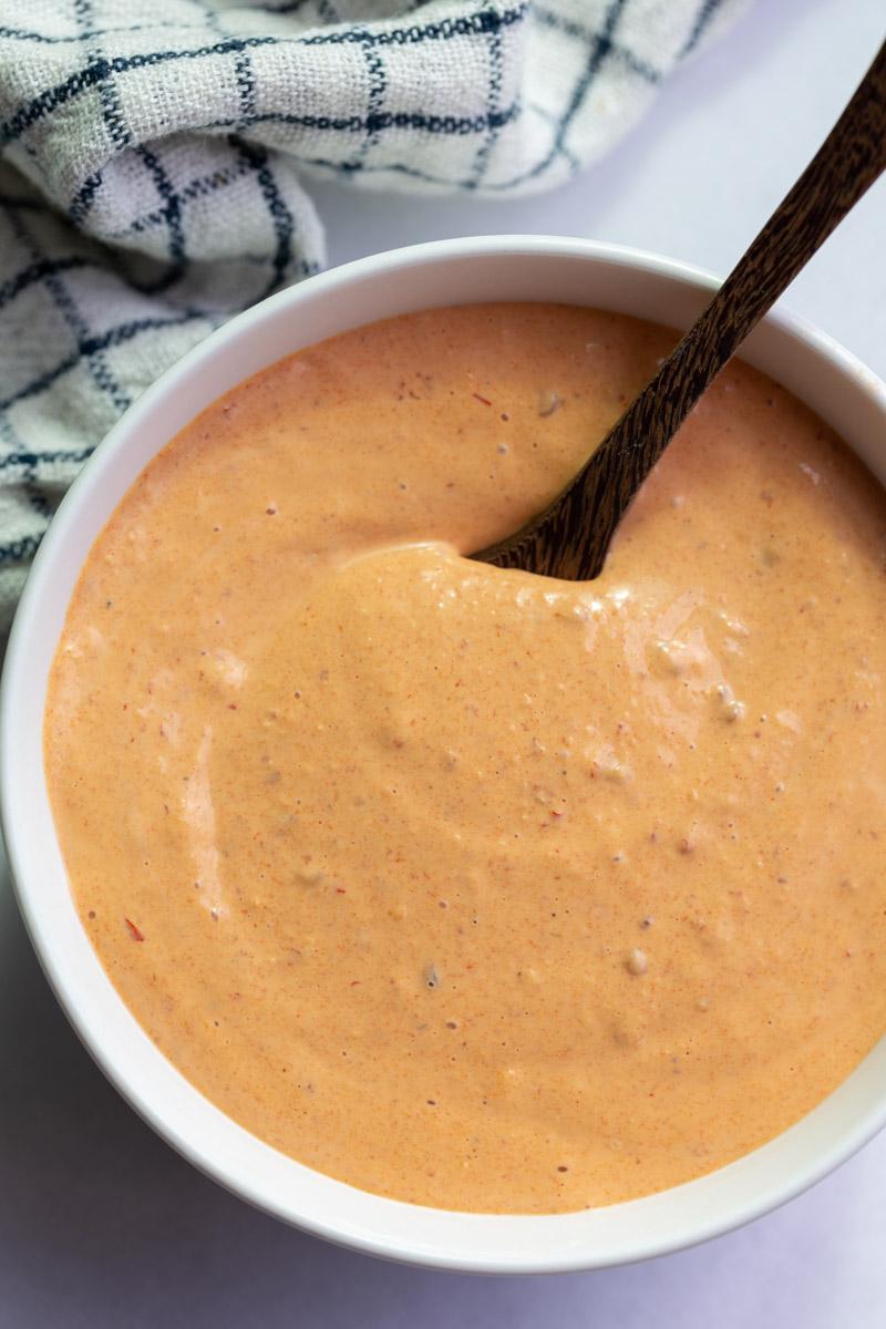 chipotle mayo sauce in a large white bowl with a spoon