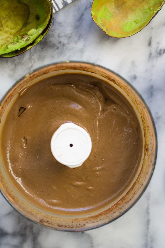 Chocolate avocado pudding blended up in a food porcessor