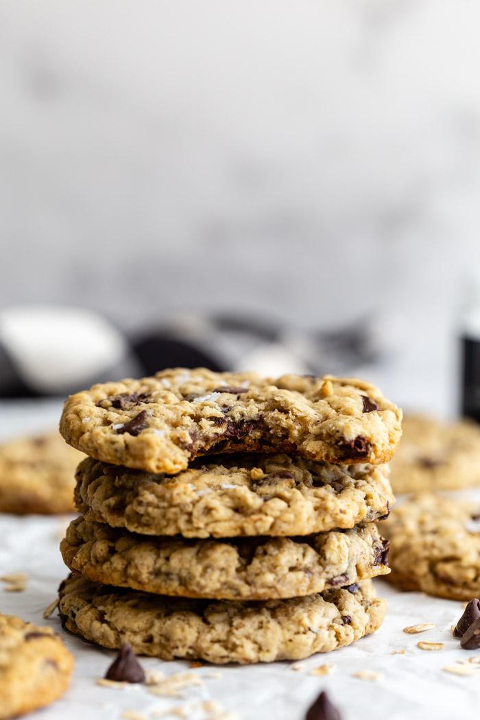 stack of oatmeal chocolate chip cookies with more in the background