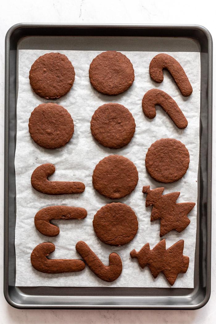 chocolate sugar cut out cookies on a baking tray lined with parchment paper
