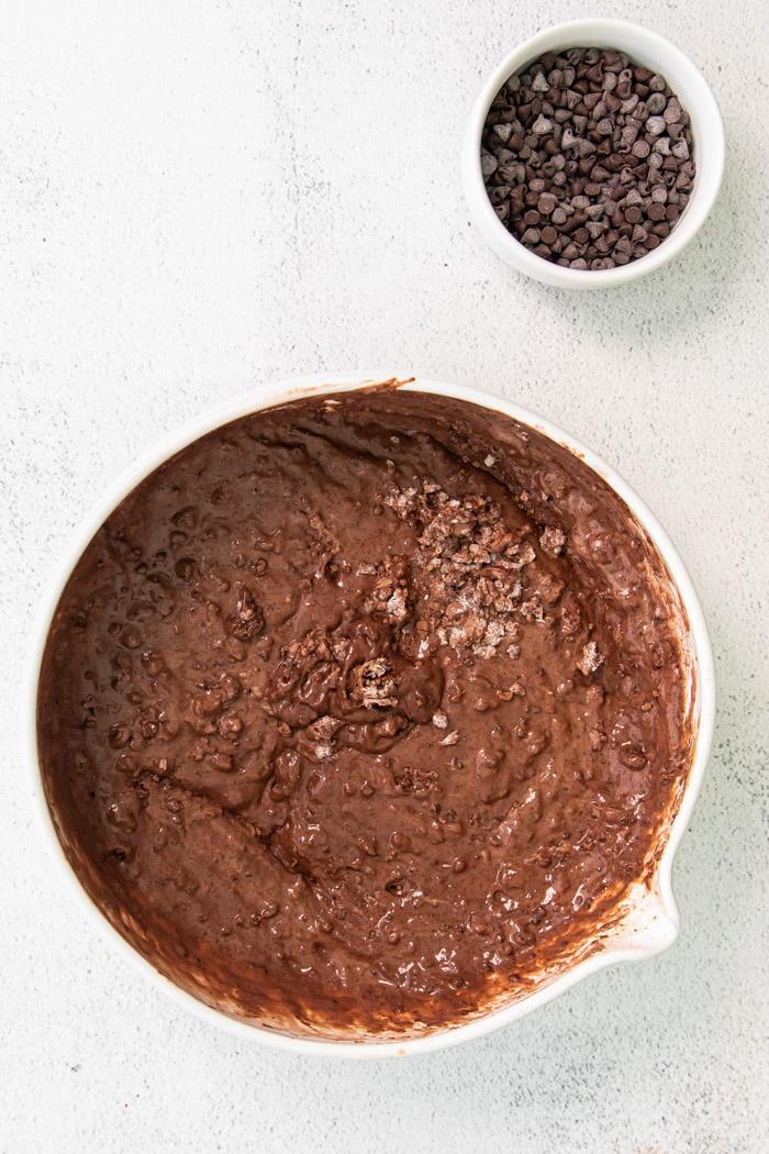 mixing batter for chocolate waffles in a large mixing bowl