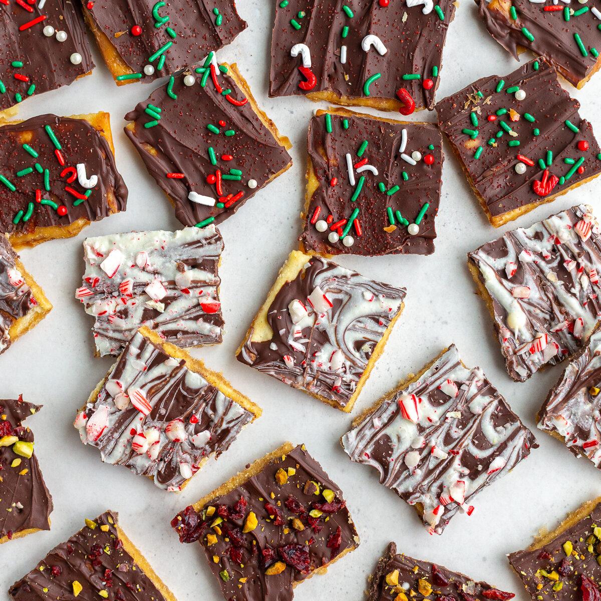 christmas crack recipe with pieces of cristmas toffee torn into small pieces and topped with various holiday toppings