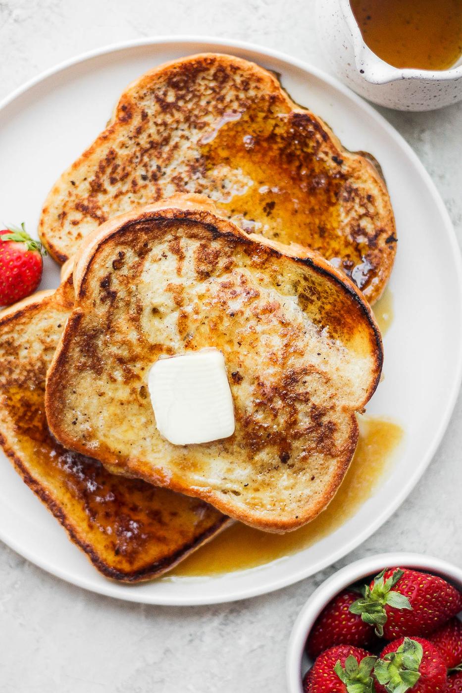 Slices of French toast on a white plate.