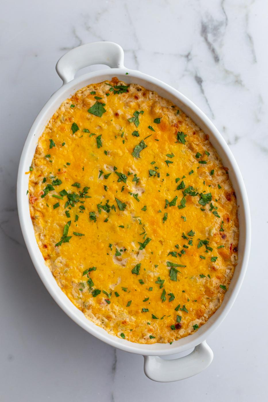 cream cheese corn dip in an oval dish