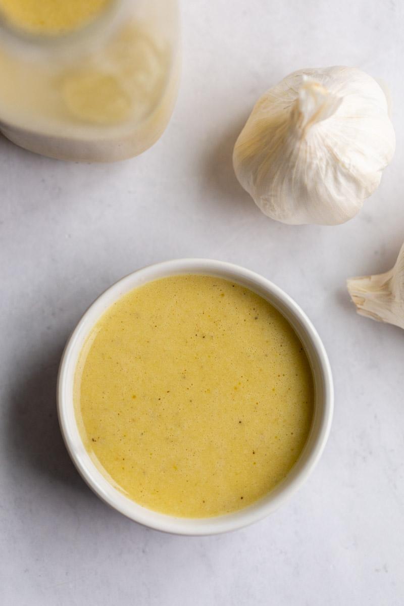 small white bowl of creamy garlic dressing
