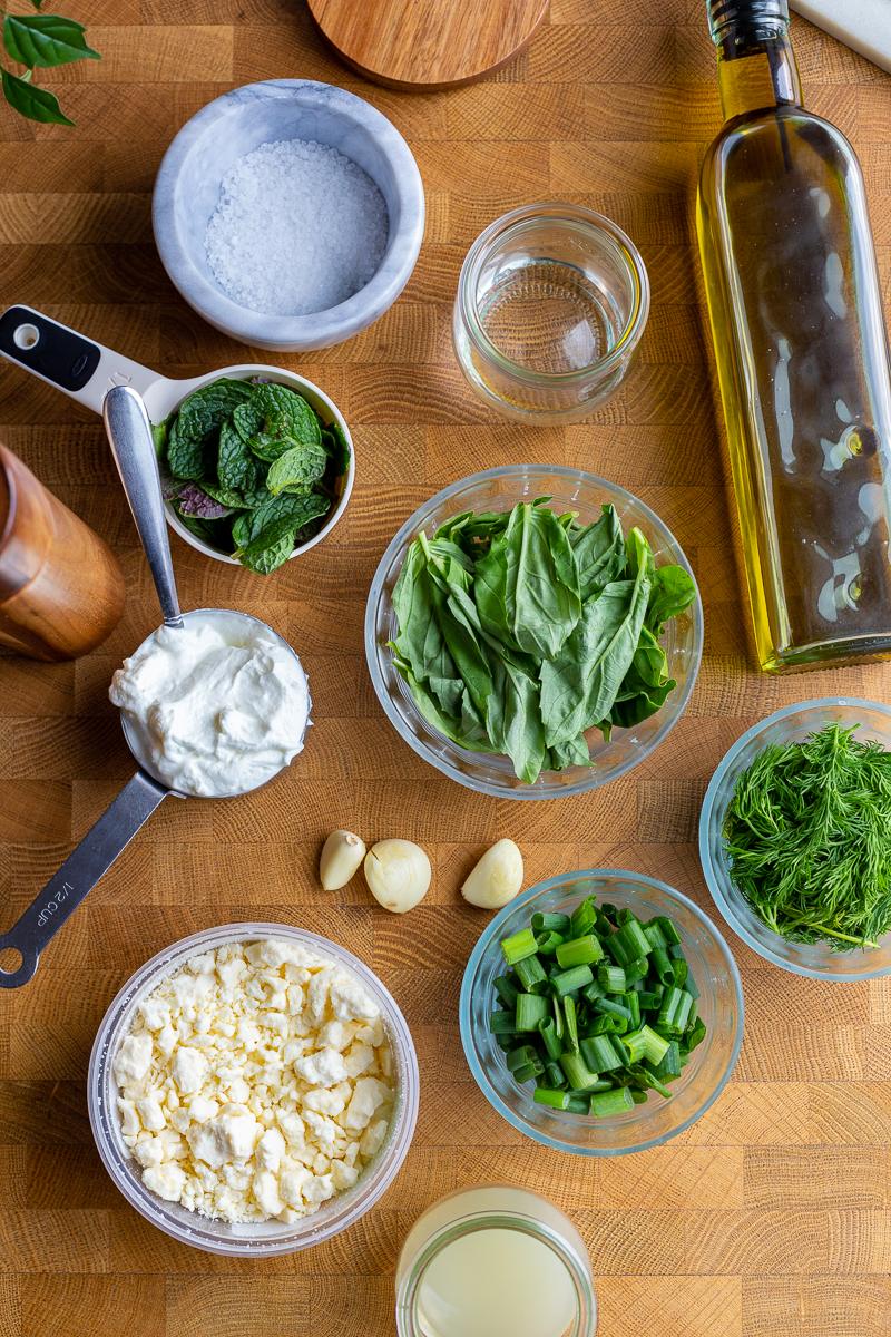 ingredients needed for this green goddess dip recipe: fresh herbs, feta, yogurt, salt and pepper, lemon juice, garlic cloves, olive oil and water and green onions
