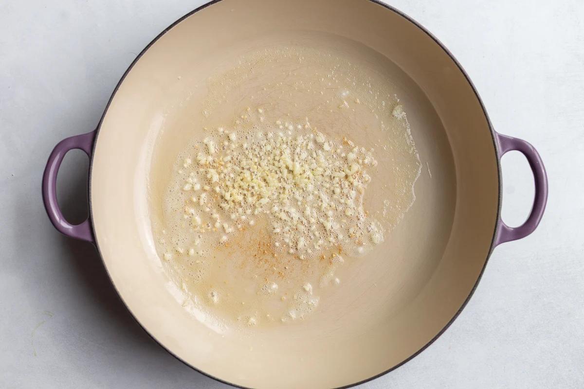 garlic sauteing in a large skillet
