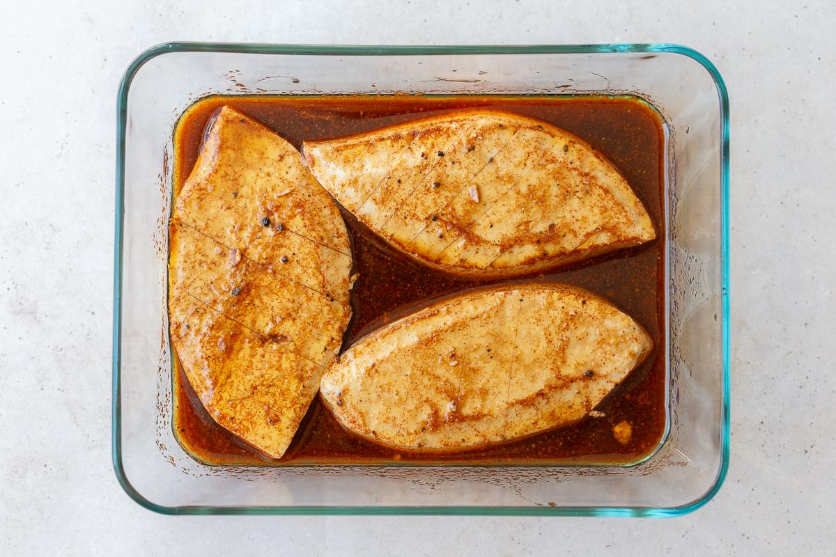 tofu "steak" marinating in a tupperware container