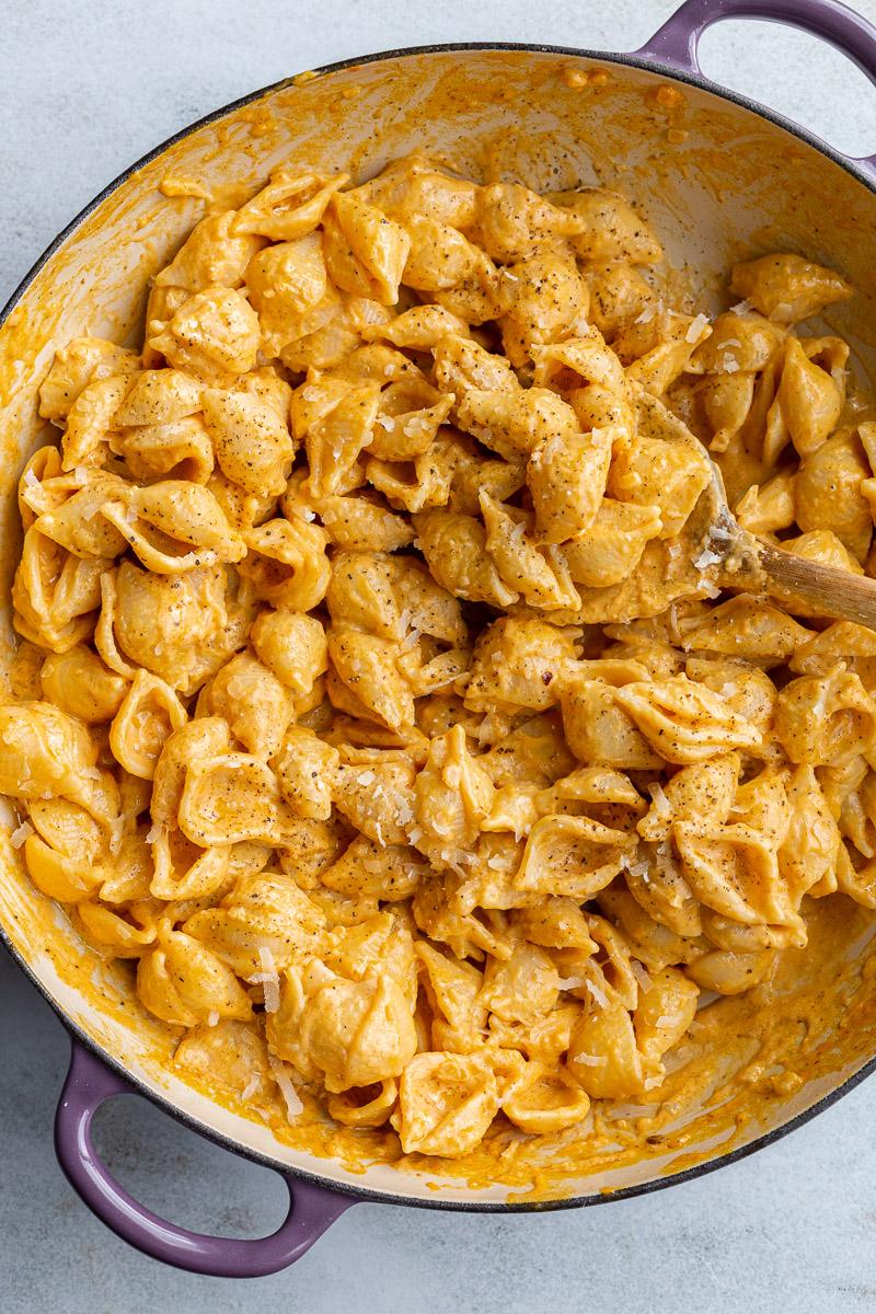 creamy pumpkin macaroni pasta in a large purple skillet