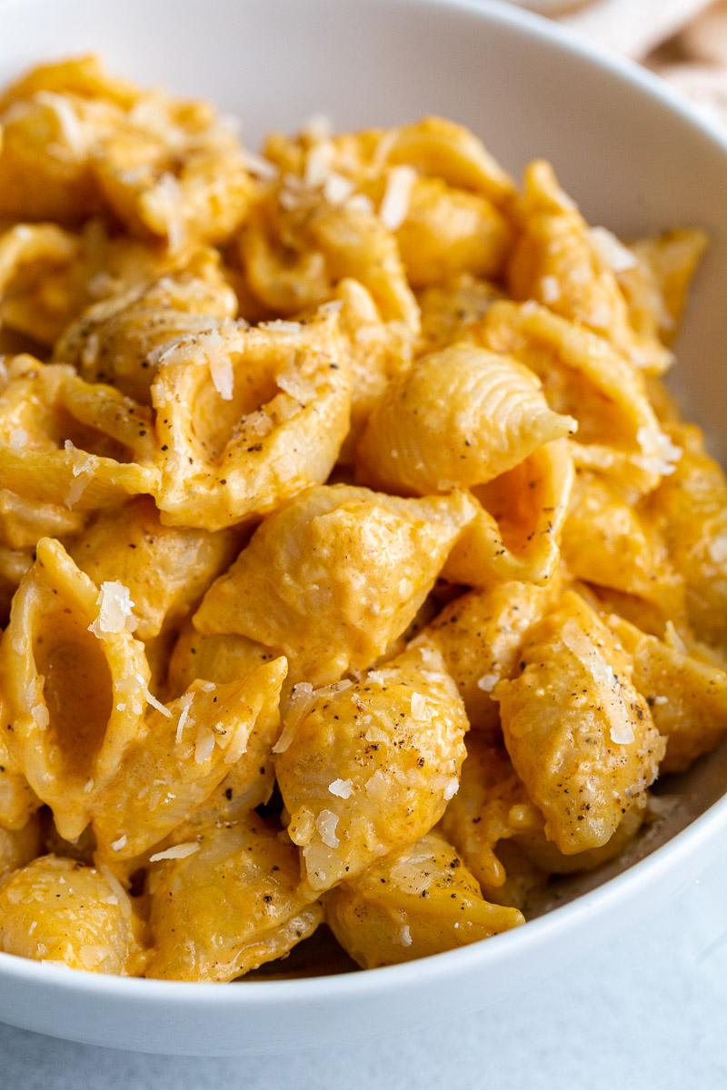 creamy pumpkin macaroni pasta with shredded parmesan on top