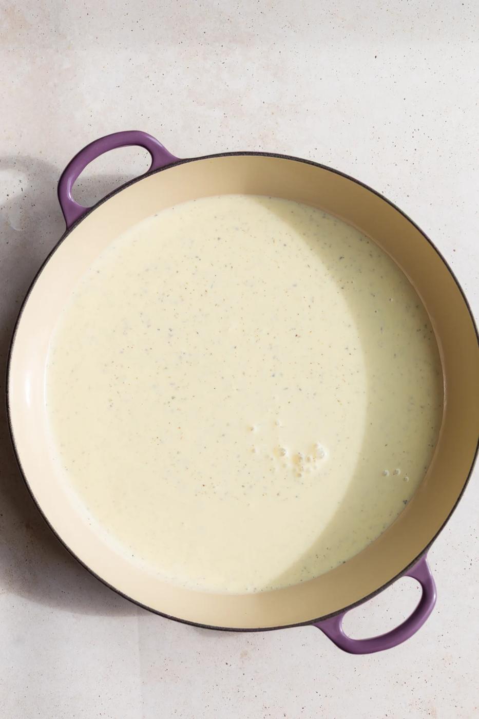 Cooking tofu pasta sauce in a large pot.