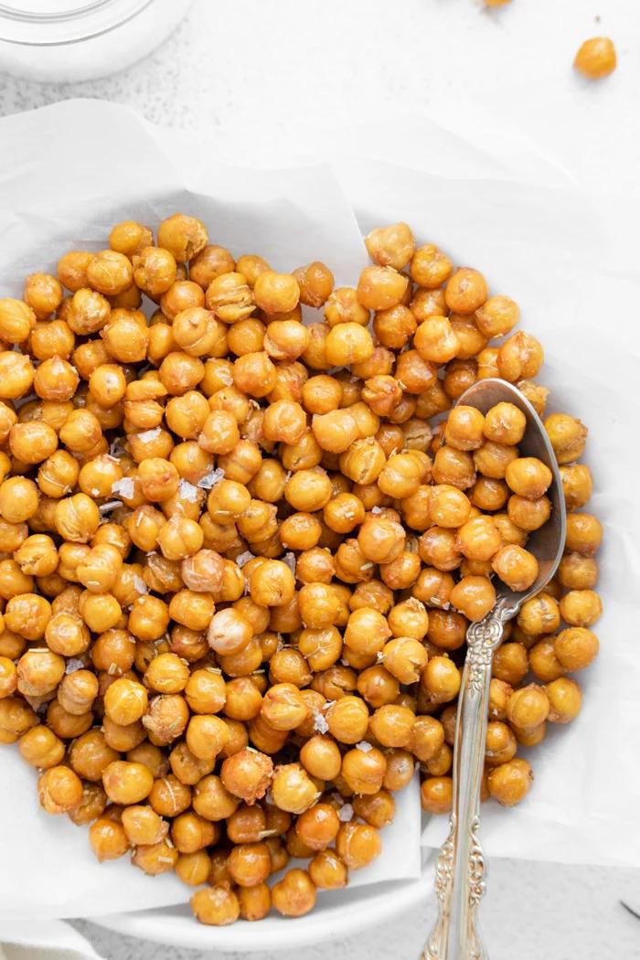 crispy chickpeas on a white plate with a spoon on the side