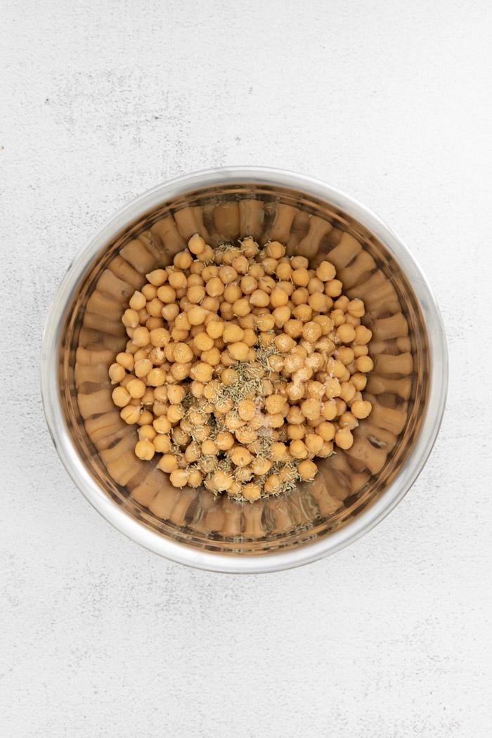 chickpeas in a metal bowl with spices