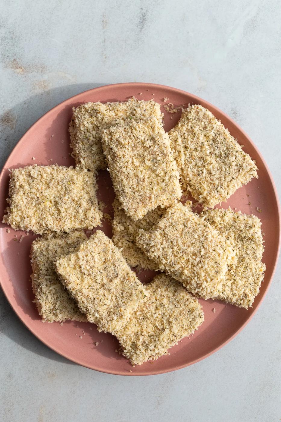 Pieces of tofu that has been coated in flour and bread crumbs.