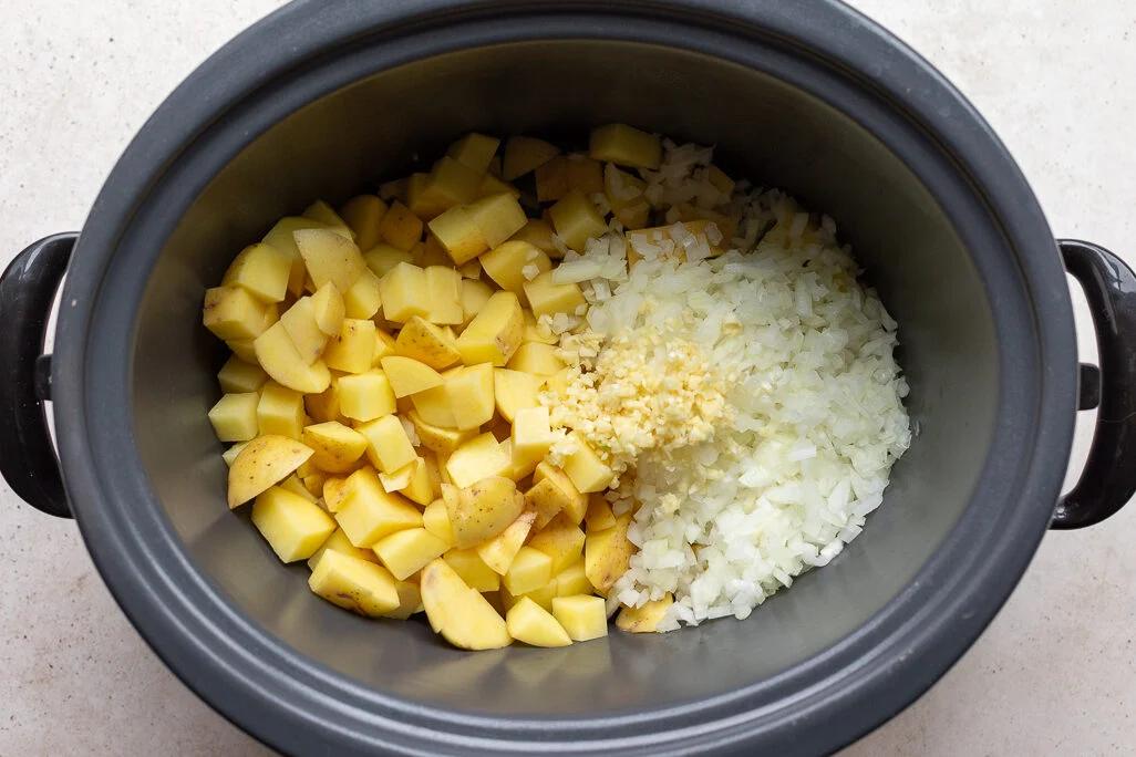 potatoes, onion and garlic in a crockpot to make slow cooke potato soup