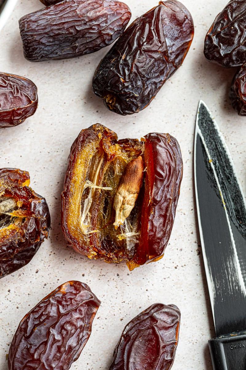 medjool date cut open to reveal the seed inside